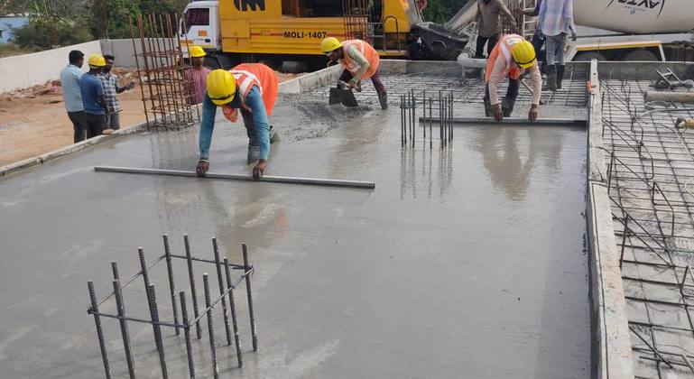 Team screeding a fresh concrete slab